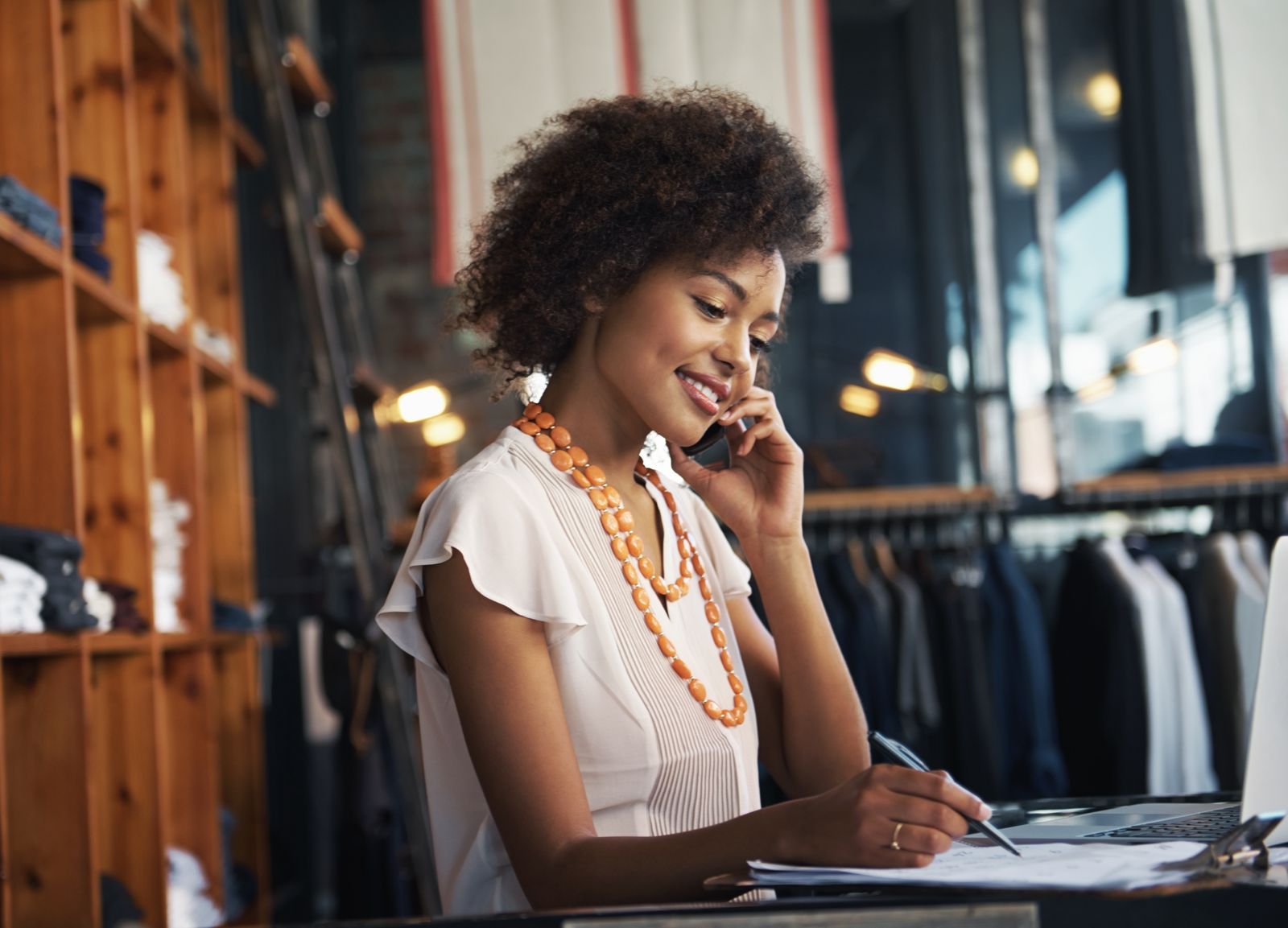 Boutique owner taking a call in her shop