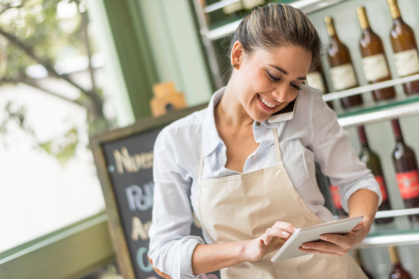 Shop owner taking a call on her mobile